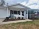 Charming single-story home featuring a covered porch, white siding, and well-maintained landscaping, complete with an attached garage at 8344 Sw 107Th Pl, Ocala, FL 34481