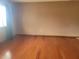 Bright living room featuring gleaming hardwood floors, neutral wall paint, and a large window for natural light at 8344 Sw 107Th Pl, Ocala, FL 34481