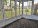 The sunroom features large windows offering tranquil views of the landscaped yard at 8344 Sw 107Th Pl, Ocala, FL 34481