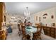 Formal dining room featuring a chandelier and wood furniture with a view into the kitchen at 8533 Sw 93Rd Pl # C, Ocala, FL 34481