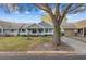Inviting home with a cozy porch and attached garage, set on a green lawn with mature trees at 8533 Sw 93Rd Pl # C, Ocala, FL 34481