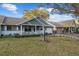 Quaint home with a charming porch, complemented by lush green lawn and shade trees at 8533 Sw 93Rd Pl # C, Ocala, FL 34481