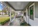 Charming front porch with a seating area, decorative greenery, and a welcoming front door at 8533 Sw 93Rd Pl # C, Ocala, FL 34481