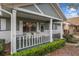 Charming front porch with seating, decorative greenery, and a welcoming front door at 8533 Sw 93Rd Pl # C, Ocala, FL 34481