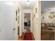 Hallway with wood floors leading to a view of a cozy living room at 8533 Sw 93Rd Pl # C, Ocala, FL 34481