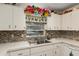 Close up of kitchen sink featuring white appliances and cabinets at 8533 Sw 93Rd Pl # C, Ocala, FL 34481