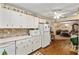 Kitchen featuring white appliances and cabinets with view into dining room at 8533 Sw 93Rd Pl # C, Ocala, FL 34481