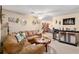 Living room showcasing comfortable sofa, bar area, and neutral carpet at 8533 Sw 93Rd Pl # C, Ocala, FL 34481