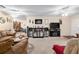 Expansive living area featuring a bar, fireplace, and views to the dining area at 8533 Sw 93Rd Pl # C, Ocala, FL 34481