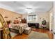 Comfortable bedroom with a ceiling fan, wood floors, and a large window at 8533 Sw 93Rd Pl # C, Ocala, FL 34481