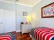 Shared bedroom featuring hardwood floors, twin beds, and a chest of drawers at 9346 Sw 73Rd St, Ocala, FL 34481