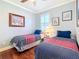 Inviting bedroom featuring twin beds, hardwood floors, and plantation shutters at 9346 Sw 73Rd St, Ocala, FL 34481