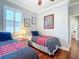 Bright bedroom with twin beds, striped bedding, and a window with shutters at 9346 Sw 73Rd St, Ocala, FL 34481
