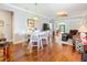 Open-concept dining area with hardwood flooring, stylish chandelier, and an adjacent living space at 9346 Sw 73Rd St, Ocala, FL 34481