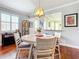 Dining area with hardwood floors, view of living areas, stylish lighting, and neutral decor at 9346 Sw 73Rd St, Ocala, FL 34481
