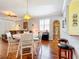 Open-concept dining area with hardwood flooring, stylish chandelier, and natural light at 9346 Sw 73Rd St, Ocala, FL 34481