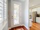 Bright foyer with decorative front door, stylish rug, and a view to the modern kitchen at 9346 Sw 73Rd St, Ocala, FL 34481