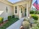 Inviting front porch features an American flag and manicured landscaping, creating a warm welcome at 9346 Sw 73Rd St, Ocala, FL 34481