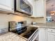 Kitchen features granite countertops, stainless steel appliances, and white cabinets at 9346 Sw 73Rd St, Ocala, FL 34481