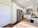 Bright kitchen features stainless steel appliances, white cabinetry, and hardwood floors at 9346 Sw 73Rd St, Ocala, FL 34481