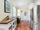 Bright kitchen featuring stainless steel appliances, white cabinets, wood floors and breakfast nook at 9346 Sw 73Rd St, Ocala, FL 34481