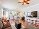 Spacious open-plan living room featuring hardwood floors, neutral walls, and a dining area with seating for four at 9346 Sw 73Rd St, Ocala, FL 34481