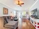 Cozy living room with hardwood floors, a comfortable sofa, and a view of the dining area at 9346 Sw 73Rd St, Ocala, FL 34481