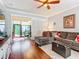 Cozy living room featuring hardwood floors, ample seating, and natural light from the sliding glass door at 9346 Sw 73Rd St, Ocala, FL 34481