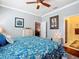 Comfortable bedroom featuring a ceiling fan, wood floors, and an ensuite bathroom with a glass shower at 9346 Sw 73Rd St, Ocala, FL 34481