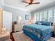 Cozy bedroom with hardwood floors, ceiling fan, a large window, and a dresser at 9346 Sw 73Rd St, Ocala, FL 34481