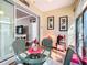 This sunroom features a glass table, wicker chairs, and access to the main living area, offering a comfortable retreat at 9346 Sw 73Rd St, Ocala, FL 34481