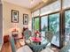 Cozy sunroom features a glass table, wicker chairs, and sliding glass doors, creating a relaxing indoor-outdoor space at 9346 Sw 73Rd St, Ocala, FL 34481