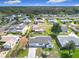 Aerial view of a single-Gathering home with a driveway, lawn, and view of the neighborhood at 9886 Se 178Th Ln, Summerfield, FL 34491