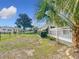 Spacious backyard with lawn, landscaping and views of other homes in the neighborhood at 9886 Se 178Th Ln, Summerfield, FL 34491