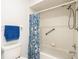 Bathroom including a tub, shower with blue patterned curtain and towel rack at 9886 Se 178Th Ln, Summerfield, FL 34491