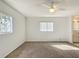 Well-lit bedroom featuring a ceiling fan, carpet flooring, and neutral wall color at 9886 Se 178Th Ln, Summerfield, FL 34491