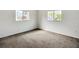 Bedroom features neutral carpet and two windows for plenty of natural light at 9886 Se 178Th Ln, Summerfield, FL 34491