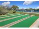 Bocce ball courts with benches are surrounded by manicured landscaping for the ultimate outdoor recreation at 9886 Se 178Th Ln, Summerfield, FL 34491
