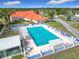 Aerial view of the large, refreshing community pool, complete with ample lounge chairs, tables, and a sun deck at 9886 Se 178Th Ln, Summerfield, FL 34491