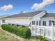 Exterior shot of the home and lawn features shrubs, awnings, and a partial fence at 9886 Se 178Th Ln, Summerfield, FL 34491