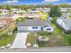 Aerial view of a single-story home with well-maintained landscaping and a two-car garage at 9886 Se 178Th Ln, Summerfield, FL 34491