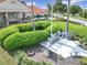 A close-up view of the Veteran's Memorial at the clubhouse with landscaping, flag pole, and trees at 9886 Se 178Th Ln, Summerfield, FL 34491