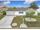 Charming home features a two-car garage, manicured front yard, and tasteful landscaping at 9886 Se 178Th Ln, Summerfield, FL 34491