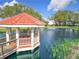 This community features a covered gazebo in the middle of a pond, offering a scenic outdoor gathering space at 9886 Se 178Th Ln, Summerfield, FL 34491