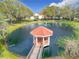 This community features a covered gazebo in the middle of a pond, offering a scenic outdoor gathering space at 9886 Se 178Th Ln, Summerfield, FL 34491
