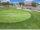 Aerial view of a vibrant green golf course, sand traps, and a red roof clubhouse at 9886 Se 178Th Ln, Summerfield, FL 34491
