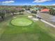 Aerial view of a lush green golf course with sand traps and putting greens at 9886 Se 178Th Ln, Summerfield, FL 34491