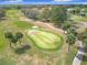 Beautiful aerial view of a well-maintained golf course, with lush greens and mature trees at 9886 Se 178Th Ln, Summerfield, FL 34491