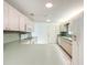Bright kitchen featuring white appliances, tile floors, and light wood cabinets at 9886 Se 178Th Ln, Summerfield, FL 34491