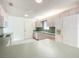 Bright kitchen featuring white appliances, tile floors, and light wood cabinets at 9886 Se 178Th Ln, Summerfield, FL 34491